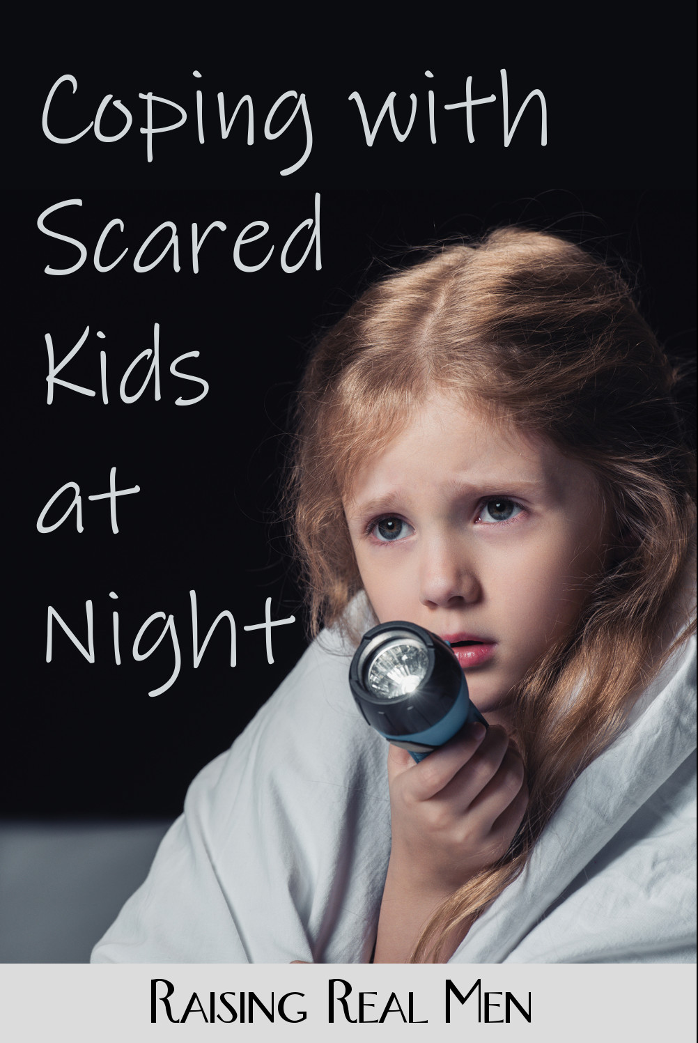 Frightened child with flashlight