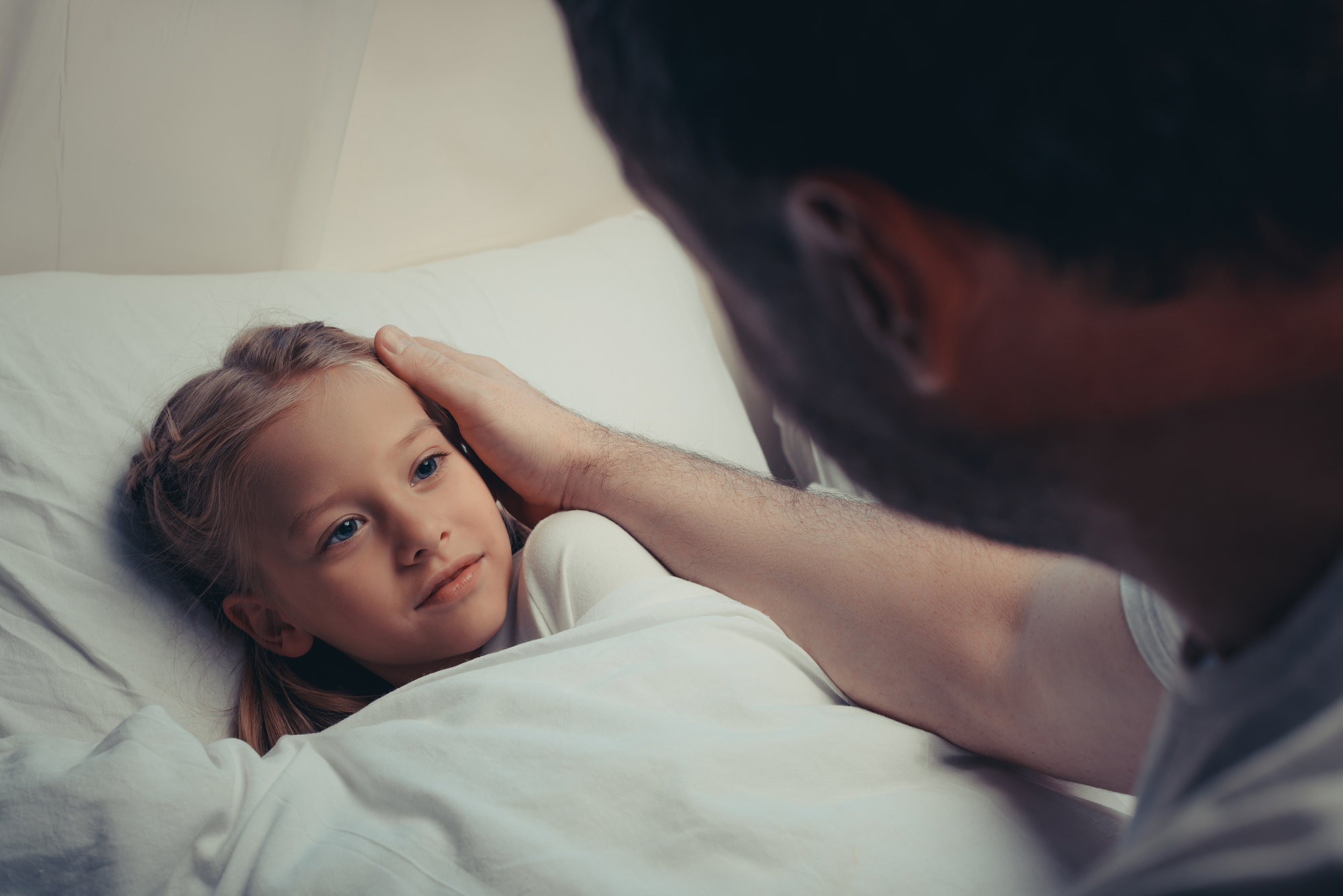 Father comforts daughter at night